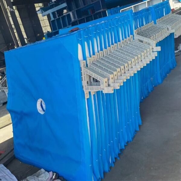 Blue filter cloths installed on filter press for industrial solid-liquid separation